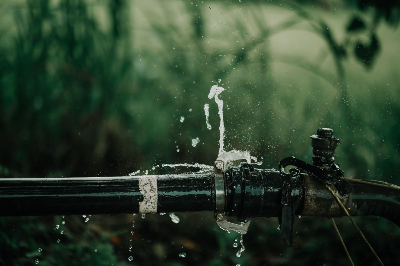 Water spraying from a burst joint on a pipe